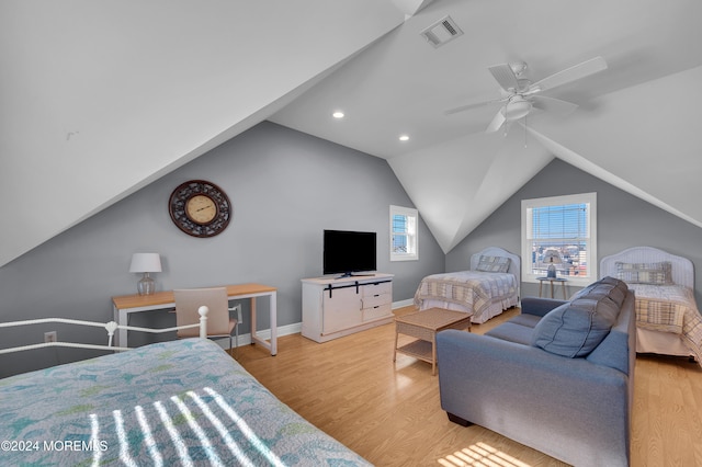 bedroom with ceiling fan, vaulted ceiling, and light wood-type flooring