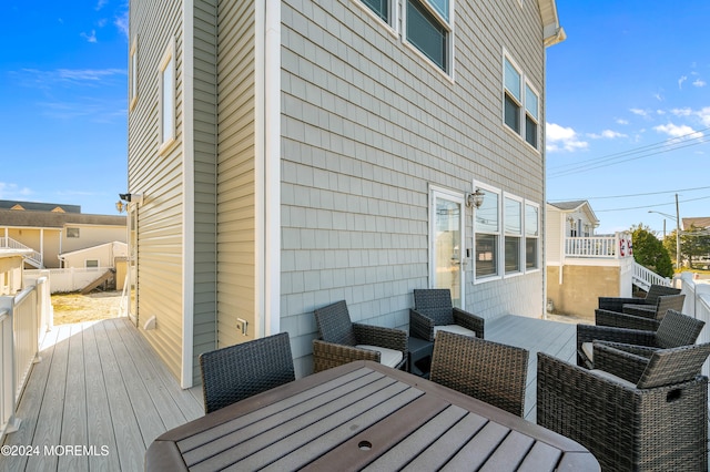 wooden terrace with an outdoor hangout area