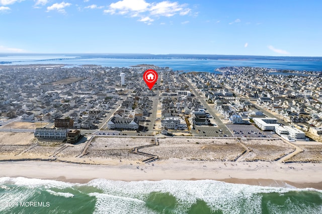 birds eye view of property featuring a view of the beach and a water view