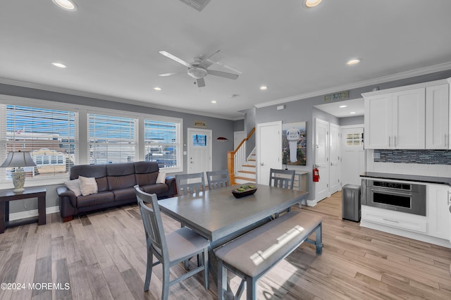 dining area featuring crown molding, light hardwood / wood-style flooring, and ceiling fan