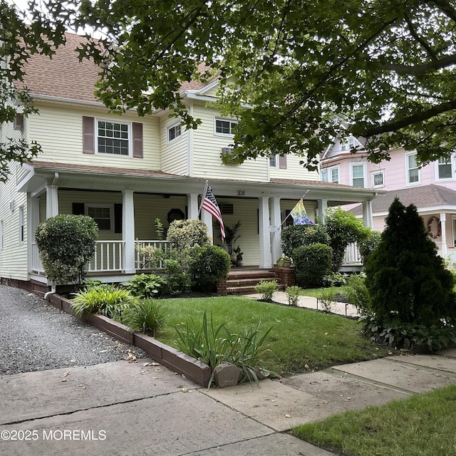 508 7th Ave Unit 2, Asbury Park, NJ 07712 - view of front facade featuring covered porch, a front yard, and a shingled roof