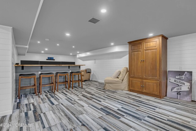 interior space featuring wood walls and light wood-type flooring