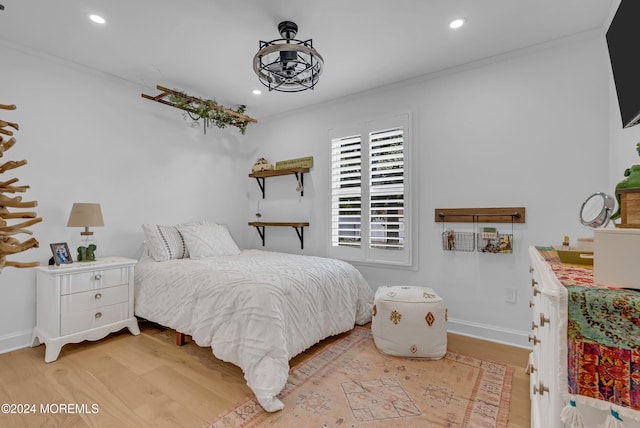 bedroom featuring light hardwood / wood-style flooring and ornamental molding