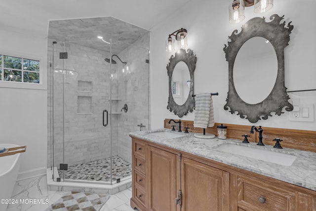 bathroom featuring a shower with shower door and vanity