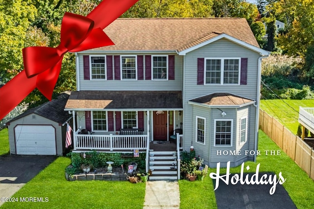 view of front of property featuring a porch, a garage, an outdoor structure, and a front lawn