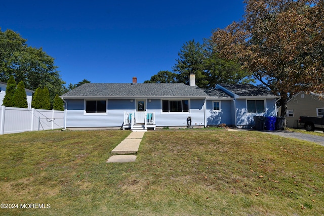 ranch-style home featuring a front yard