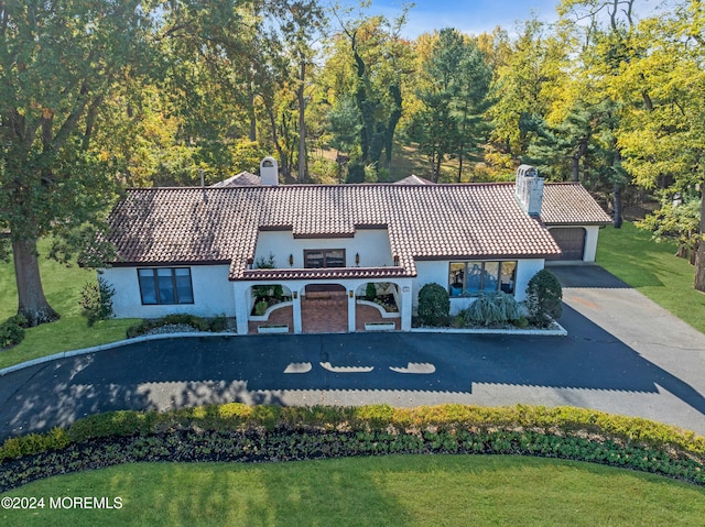 mediterranean / spanish-style home featuring a front yard