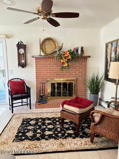 tiled living area with ceiling fan, a brick fireplace, a baseboard radiator, and ornamental molding