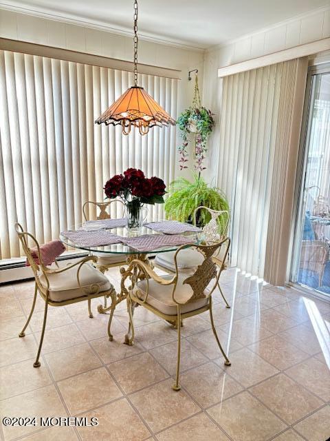 dining space featuring light tile patterned floors and ornamental molding