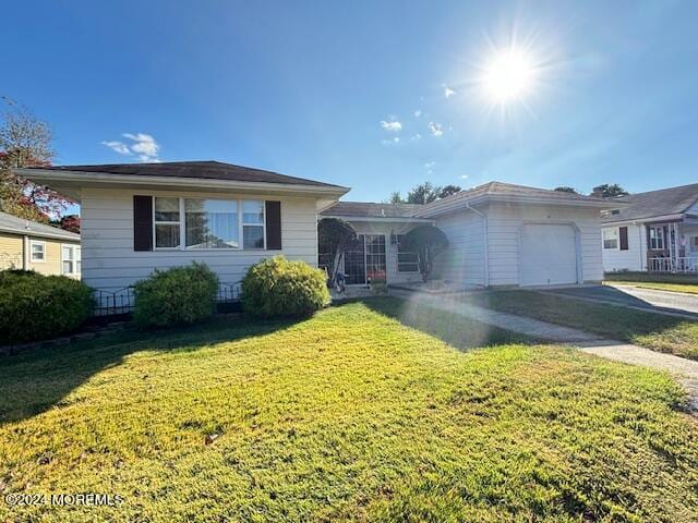 view of front of property with driveway, a front lawn, and an attached garage