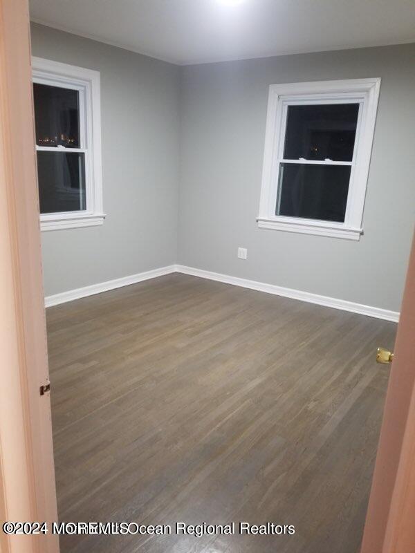 empty room featuring dark hardwood / wood-style flooring