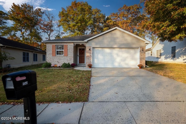 view of front of home with a front lawn and a garage