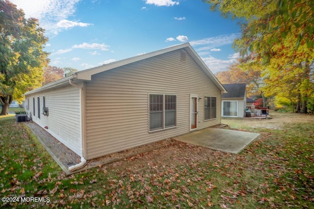 rear view of property featuring central air condition unit and a patio