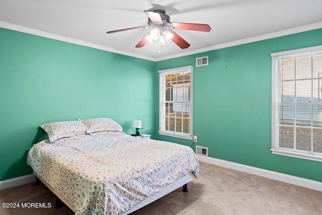 bedroom featuring multiple windows, ornamental molding, carpet, and ceiling fan