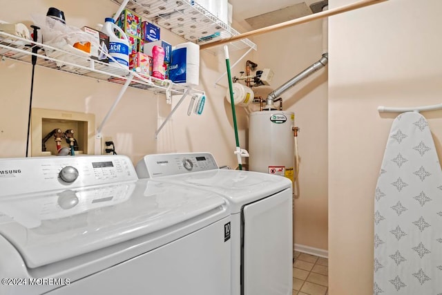 laundry area featuring independent washer and dryer, gas water heater, and tile patterned flooring