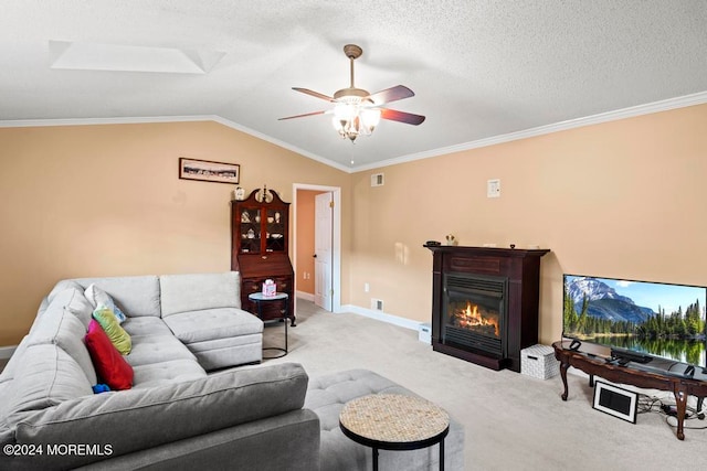 living room featuring ceiling fan, a textured ceiling, crown molding, lofted ceiling with skylight, and light colored carpet