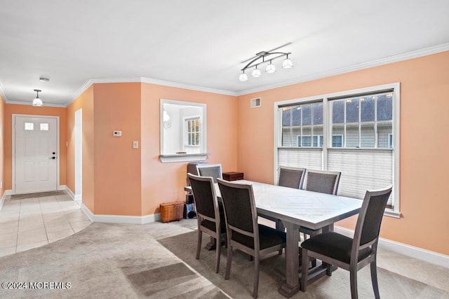 carpeted dining room featuring crown molding