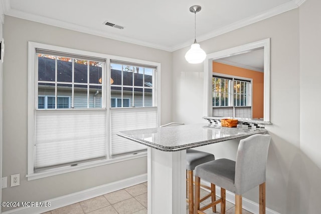 dining area featuring ornamental molding and light tile patterned floors