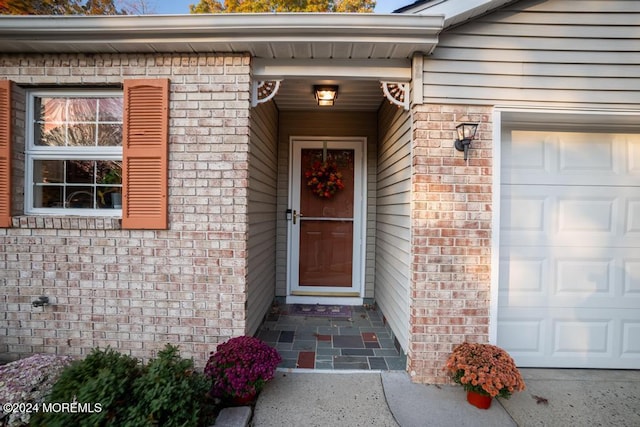 view of exterior entry with a garage