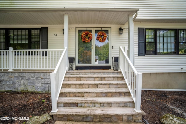 view of exterior entry with a porch