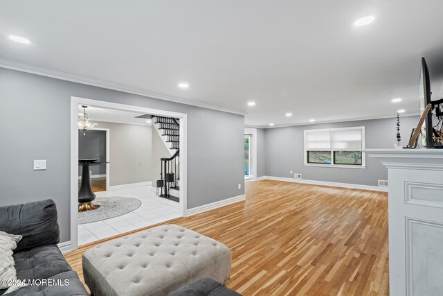 living room featuring light hardwood / wood-style flooring and ornamental molding