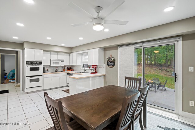 dining room with sink, ceiling fan, and light tile patterned floors