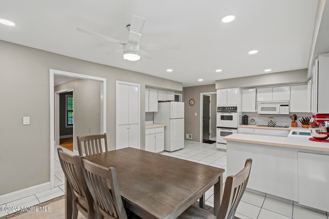 tiled dining space featuring sink and ceiling fan