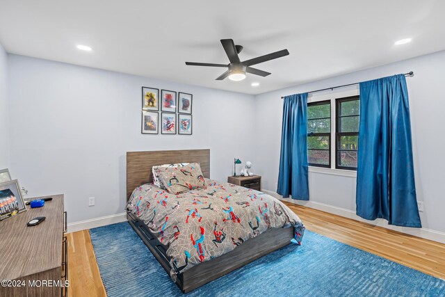 bedroom featuring ceiling fan and hardwood / wood-style flooring