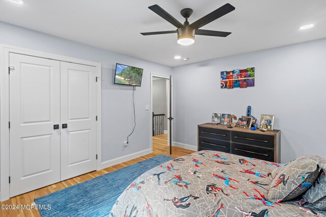 bedroom featuring a closet, hardwood / wood-style flooring, and ceiling fan