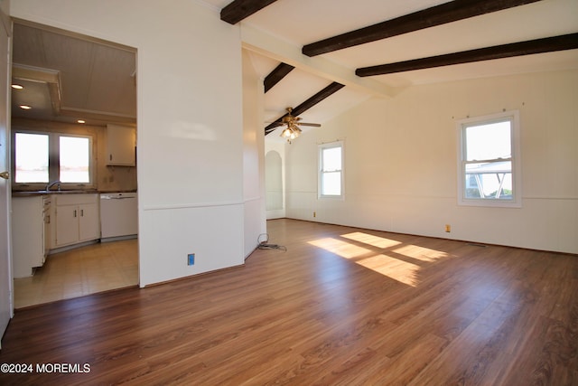 unfurnished living room with sink, light hardwood / wood-style flooring, vaulted ceiling with beams, and ceiling fan