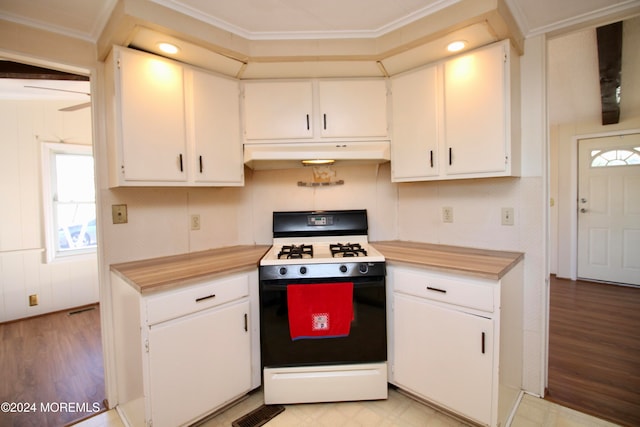 kitchen featuring ornamental molding, white cabinetry, a healthy amount of sunlight, and white range