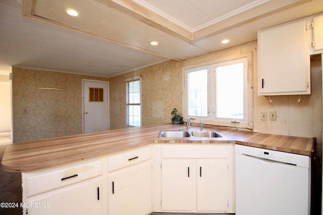 kitchen featuring sink, dishwasher, kitchen peninsula, white cabinets, and crown molding