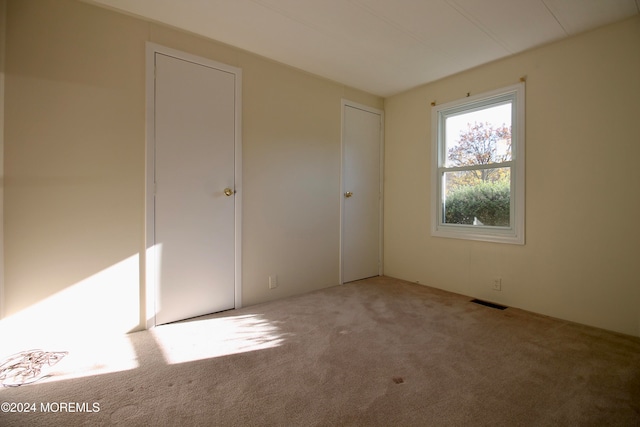 spare room with light colored carpet