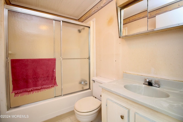 full bathroom featuring vanity, bath / shower combo with glass door, and toilet