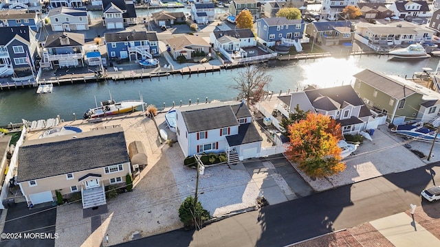 birds eye view of property featuring a water view and a residential view
