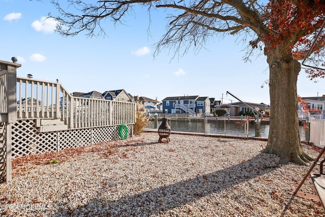 view of yard featuring a deck with water view