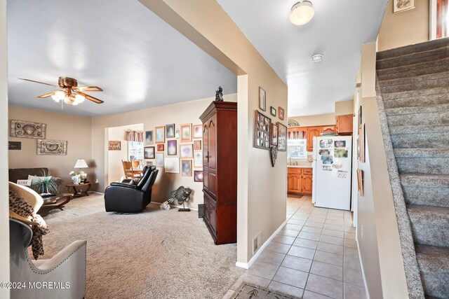 interior space featuring ceiling fan and light tile patterned floors