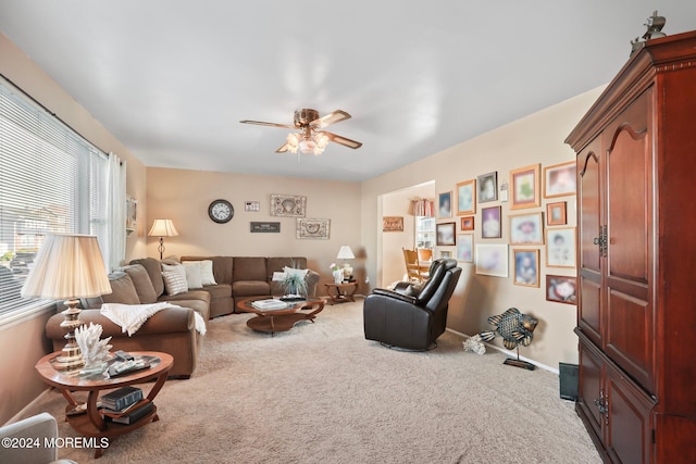 carpeted living room with ceiling fan