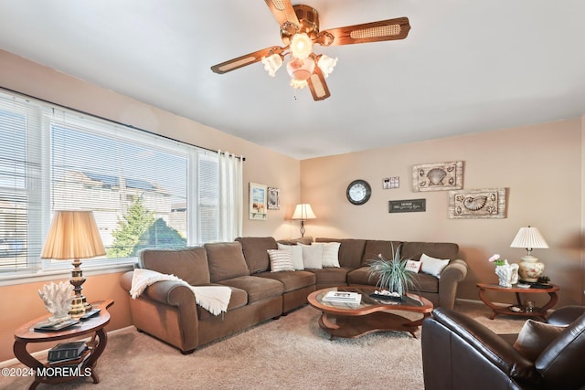 carpeted living area featuring ceiling fan