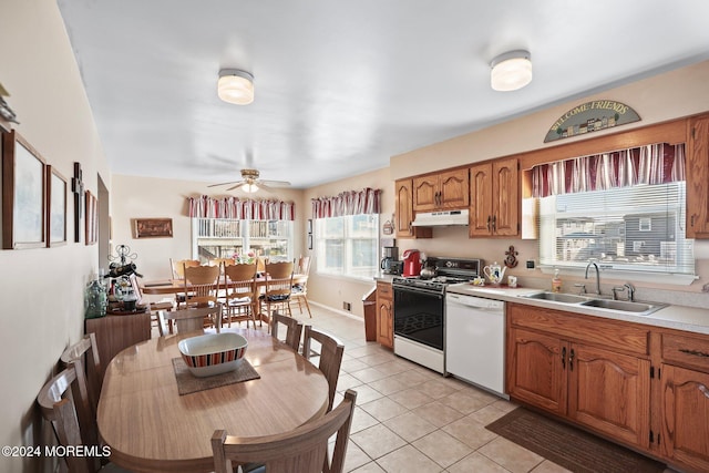 kitchen featuring ceiling fan, sink, light tile patterned floors, and white appliances