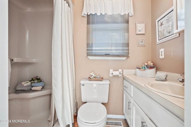 bathroom featuring vanity, toilet, and a shower with curtain