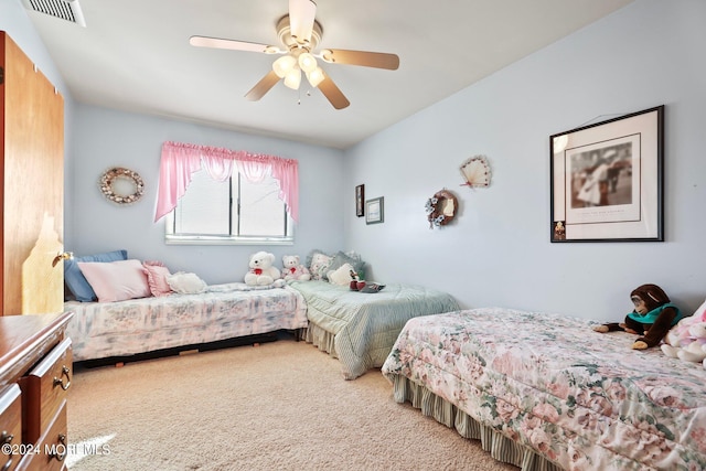 bedroom with visible vents, a ceiling fan, and carpet flooring