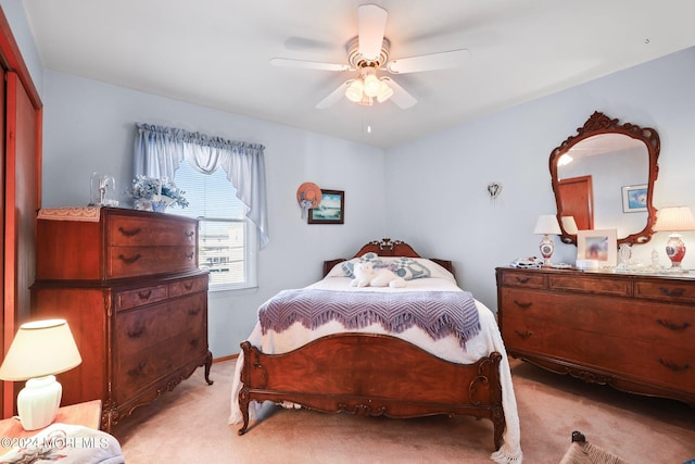 bedroom featuring a closet, ceiling fan, and light carpet