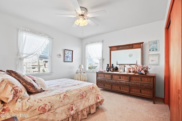 carpeted bedroom featuring a closet and ceiling fan