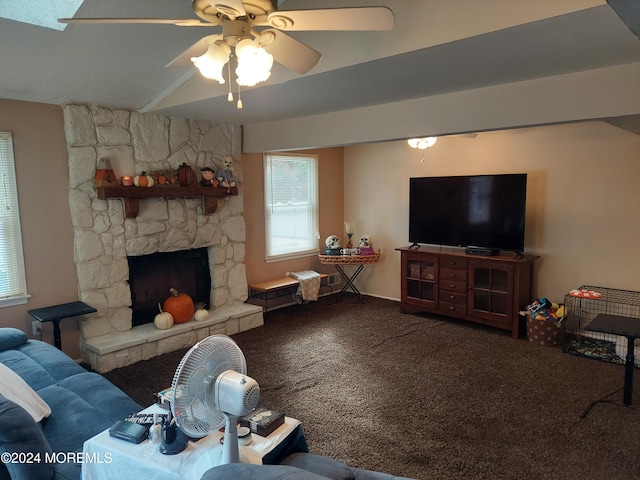 living room featuring ceiling fan, a stone fireplace, and carpet floors