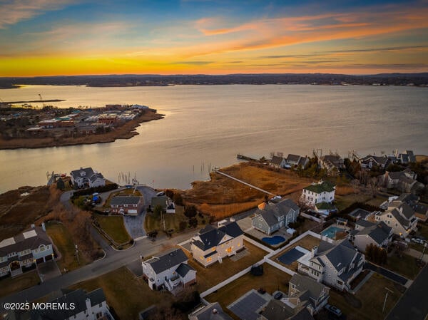 aerial view at dusk with a water view