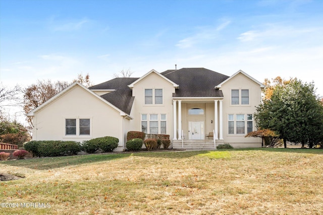 view of property featuring a front lawn