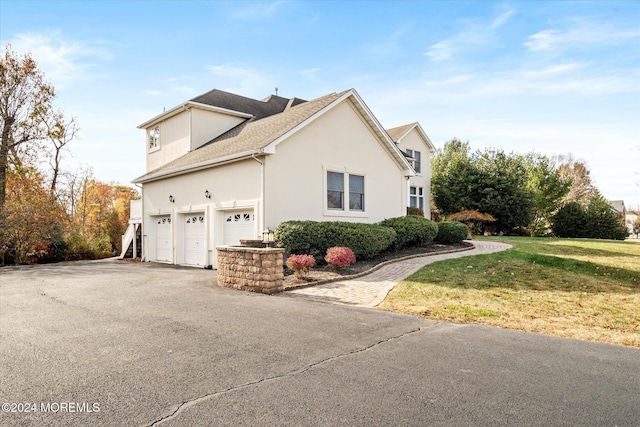 24 Clearwater Dr, Allentown, NJ 08501 - view of home's exterior featuring driveway, stucco siding, a yard, and an attached garage