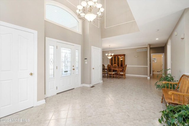 foyer with a towering ceiling and an inviting chandelier