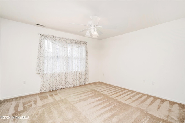 unfurnished room with carpet and ceiling fan